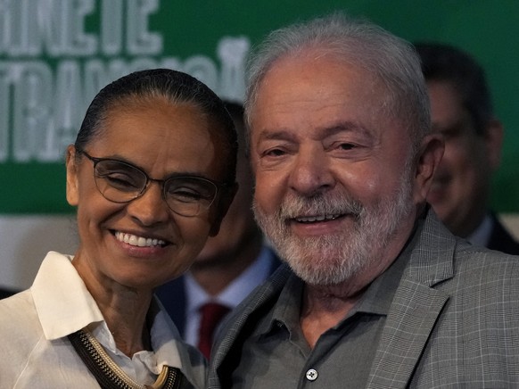 Brazil&#039;s President-elect Luiz Inacio Lula da Silva and his newly-named Environment Minister Marina Silva, smile as they pose for photos during a meeting where he announced the ministers for his i ...