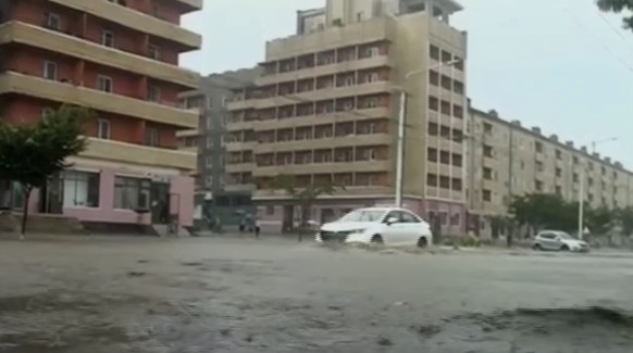 In this image taken from undated North Korean state broadcaster video, vehicles pass through flooded streets after heavy rains across South Hamgyong Province, North Korea. (KRT via APTV)