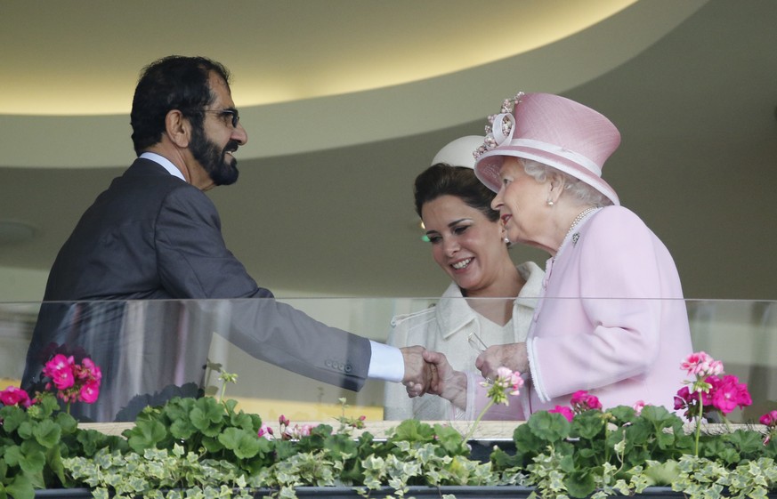 Britain&#039;s Queen Elizabeth II, right, greets Sheikh Mohammed Bin Rashid Al Maktoum, UAE Vice President and the Ruler of Dubai and his wife Princess Haya of Jordan in the royal box on the second da ...