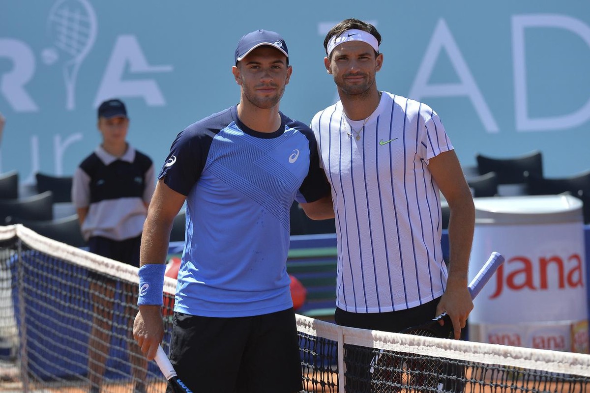 In this photo taken Saturday, June 20, 2020, Bulgaria's Grigor Dimitrov, right, poses for cameras with Croatia's Borna Coric during their semifinal match at a tournament in Zadar, Croatia. D ...