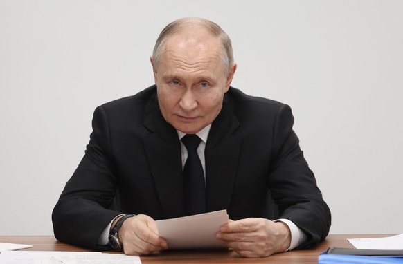 epa11908160 Russian President Vladimir Putin holds a meeting during a visit to the Radar MMS research and production enterprise, manufacturing air and sea drones, in St. Petersburg, Russia, 19 Februar ...