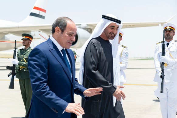 epa12939445 A handout picture released by the UAE's Presidential Court shows Sheikh Mohamed bin Zayed Al Nahyan (R), President of the United Arab Emirates and Ruler of the emirate of Abu Dhabi, w ...