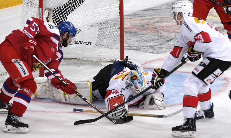 Swiss goalie Gilles Senn makes a save from Czech player Roman Horak, left, during the Ice Hockey Euro Hockey Tour Karjala Cup match between Czech Republic and Switzerland in Helsinki, Finland on Frida ...