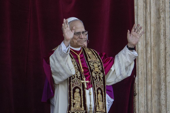 Newly elected Pope Leo XIV, formerly Cardinal Robert Francis Prevost, appears on the central loggia of St. Peter&#039;s Basilica at the Vatican shortly after his election as the 267th pontiff of the R ...