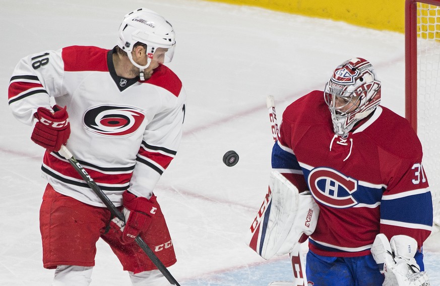 Montreal Canadiens goaltender Carey Price makes a save against Carolina Hurricanes&#039; Jay McClement during the first period of NHL hockey game in Montreal, Thursday, Nov. 24, 2016. (Graham Hughes/T ...