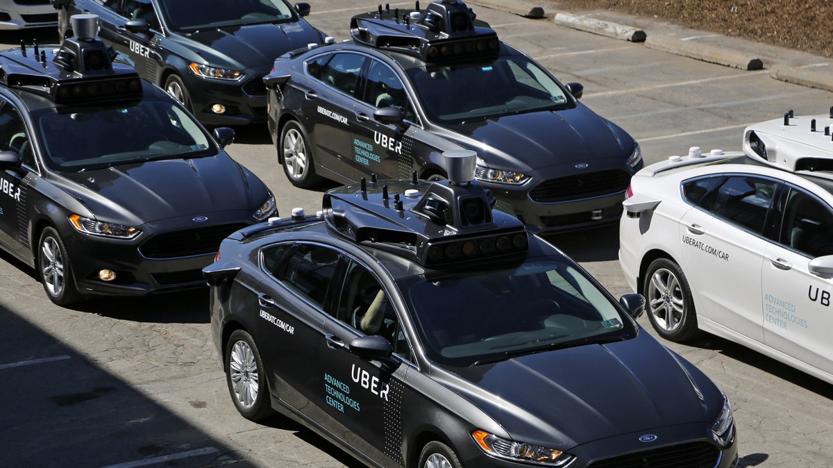 FILE- This Sept. 12, 2016, file photo, shows group of self driving Uber vehicles position themselves to take journalists on rides during a media preview at Uber's Advanced Technologies Center in  ...