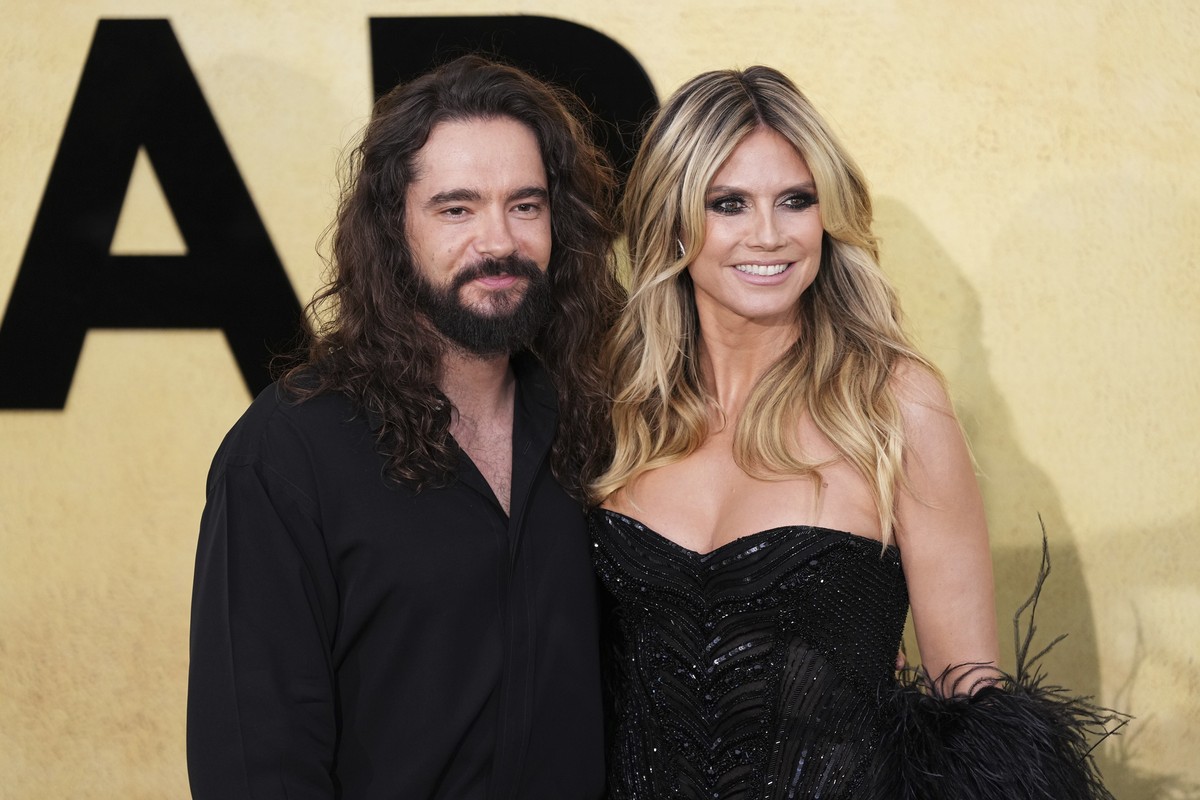 Tom Kaulitz, left, and Heidi Klum pose for photographers upon arrival at the amfAR Cinema Against AIDS benefit at the Hotel du Cap-Eden-Roc, during the 78th Cannes international film festival, Cap d&# ...