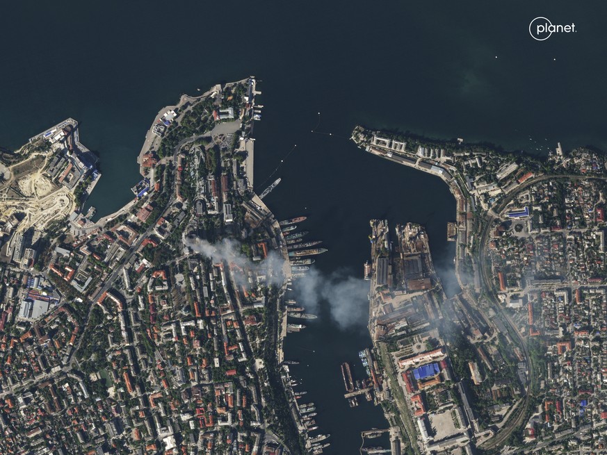 In this satellite photo provided by Planet Labs, smoke billows from a headquarters building for the Russian Black Sea fleet in Sevastopol, Crimea on Friday, Sept. 22, 2023, after it was struck in a mi ...