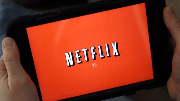 FILE - In this Friday, Jan. 17, 2014, file photo, a person displays Netflix on a tablet in North Andover, Mass. From Netflix, Spotify and Amazon Prime to Blue Apron, Birchbox and beer of the month, yo ...