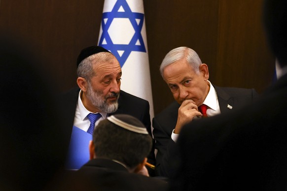 epa10413638 (FILE) - Israeli Prime Minister Benjamin Netanyahu (R) speaks with Interior and Health Minister Aryeh Deri during a weekly cabinet meeting at the Prime Minister's office in Jerusalem, Jan. 08...