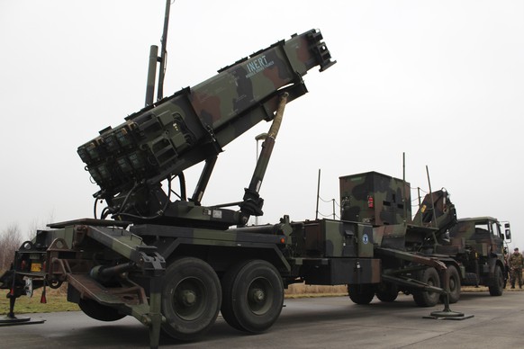 A camouflaged convoy of Dutch military trucks carrying two batteries of Patriot missiles is lined up for a media opportunity before departing De Peel Air Base in Vreedepeel, southern Netherlands, Mond ...