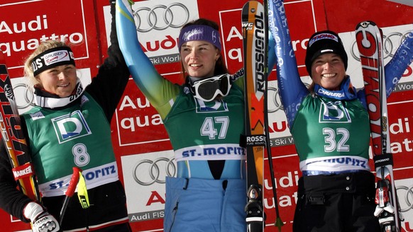 Tina Maze, of Slovenia, center, winner of an alpine ski, women's World Cup Downhill race, celebrates on the podium with second placed Maria Holaus, of Austria, left, and third placed Lara Gut, of Swit ...