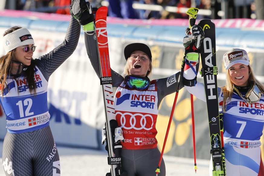 France&#039;s Tessa Worley, center, winner of an alpine ski, women&#039;s World Cup giant slalom, celebrates with second placed Italy&#039;s Sofia Goggia, left, and third placed Switzerland&#039;s Lar ...