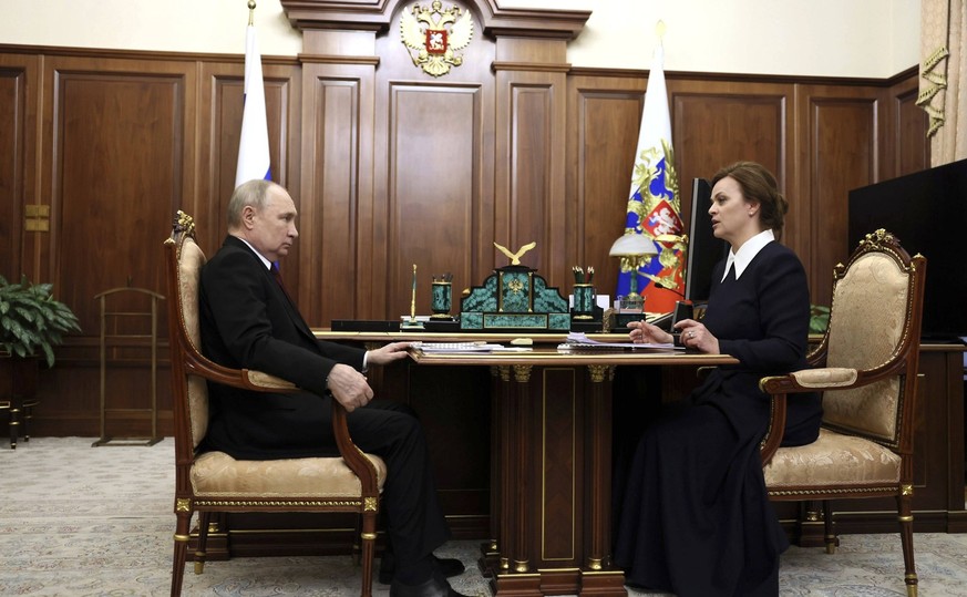 April 2, 2024, Moscow, Moscow Oblast, Russia: Russian President Vladimir Putin, left, listens to Defenders of the Fatherland Foundation head Anna Tsivilyova, right, during a meeting at the Kremlin, Ap ...