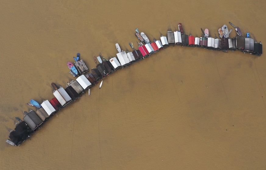Dredging barges operated by illegal miners converge on the Madeira river, a tributary of the Amazon river, searching for gold, in Autazes, Amazonas state, Brazil, Thursday, Nov.25, 2021. Hundreds of m ...