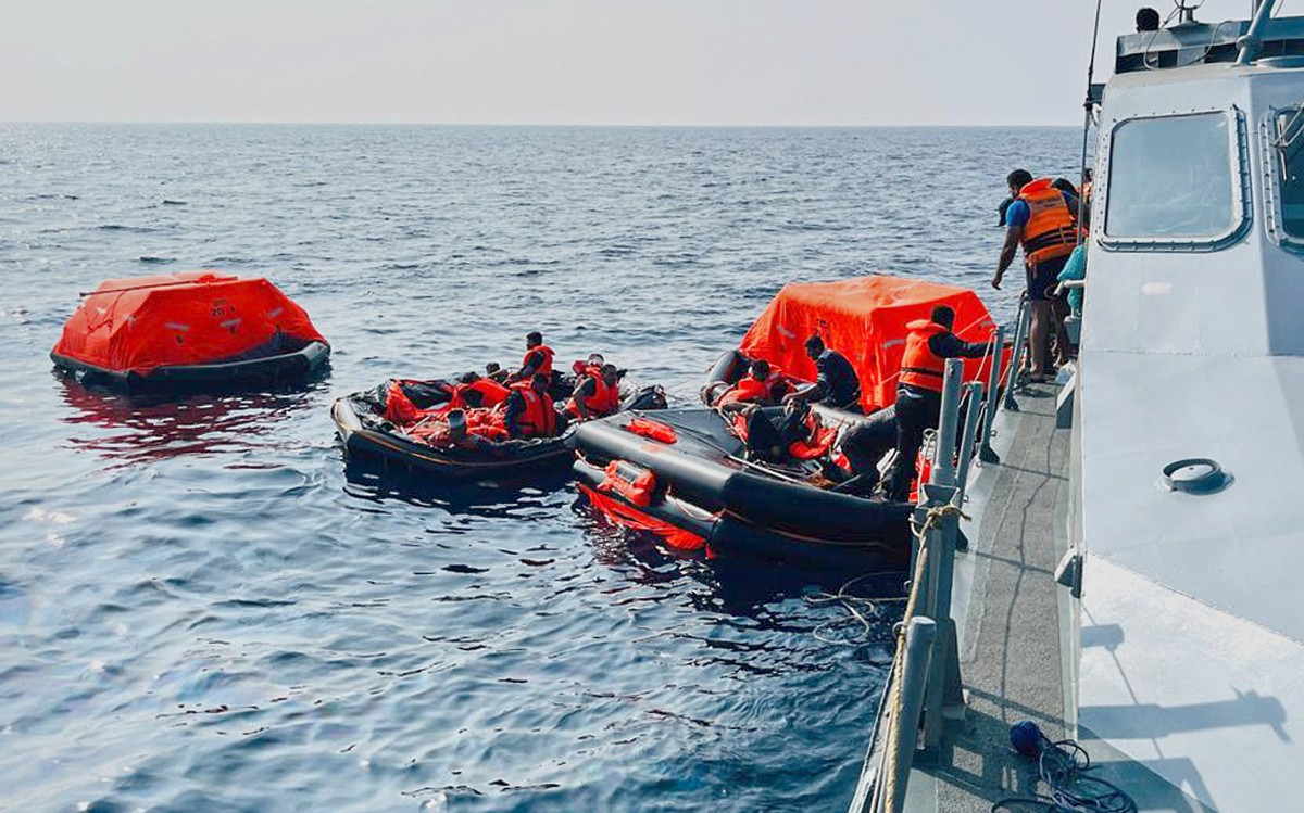 In this photo released by Sri Lankan President Media Division, Sri Lankan Navy sailors rescue Iranian sailors from IRIS Dena warship after their ship sank outside Sri Lanka's territorial waters,  ...