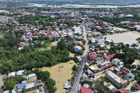 In this photo provided by the Cagayan Police Provincial Office, a town is surrounded by floodwaters after the onslaught of Typhoon Fung-wong in Cagayan province, northern Philippines on Tuesday Nov. 1 ...