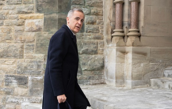 Prime Minister Mark Carney speaks with photographers as he arrives on Parliament Hill in Ottawa, Tuesday, Feb. 10, 2026.(Adrian Wyld /The Canadian Press via AP)
Canada Carney