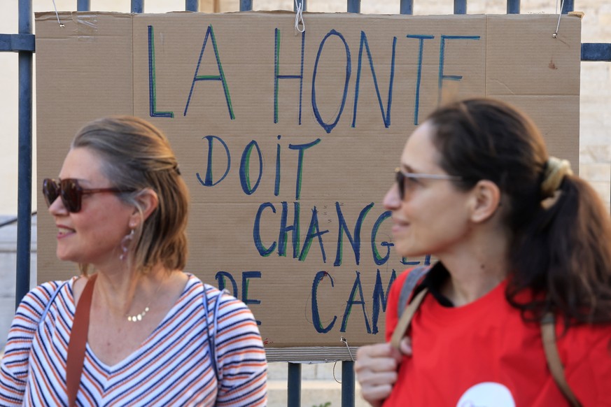 epa11669103 Participants stand next to a placard that reads &#039;The shame has to change of side, as Feminist group attend a rally in Montpellier, Southern France, 19 October 2024. The Feminist group ...