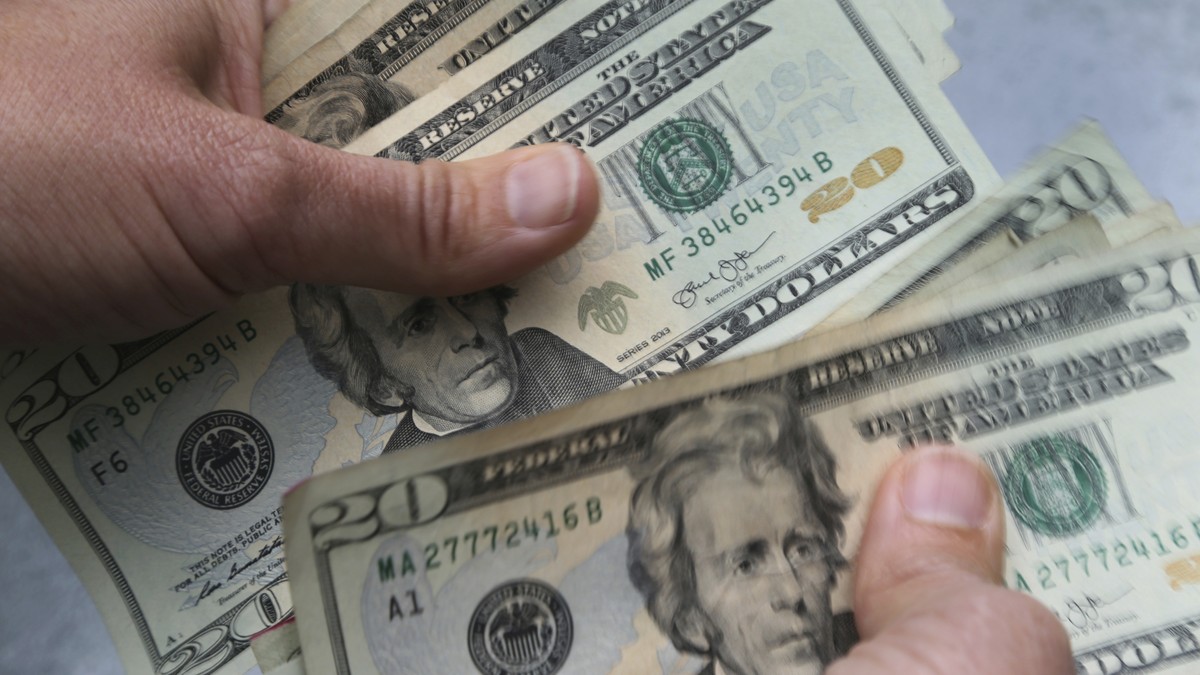 FILE - In this June 15, 2018 photo, twenty dollar bills are counted in North Andover, Mass. The cash-stuffing method of budgeting has revived the popularity of an old concept known as the envelope sys ...