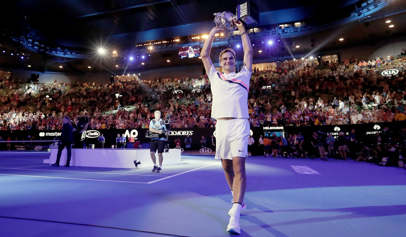 Switzerland&#039;s Roger Federer holds his trophy up after defeating Croatia&#039;s Marin Cilic in the men&#039;s singles final at the Australian Open tennis championships in Melbourne, Australia, Sun ...