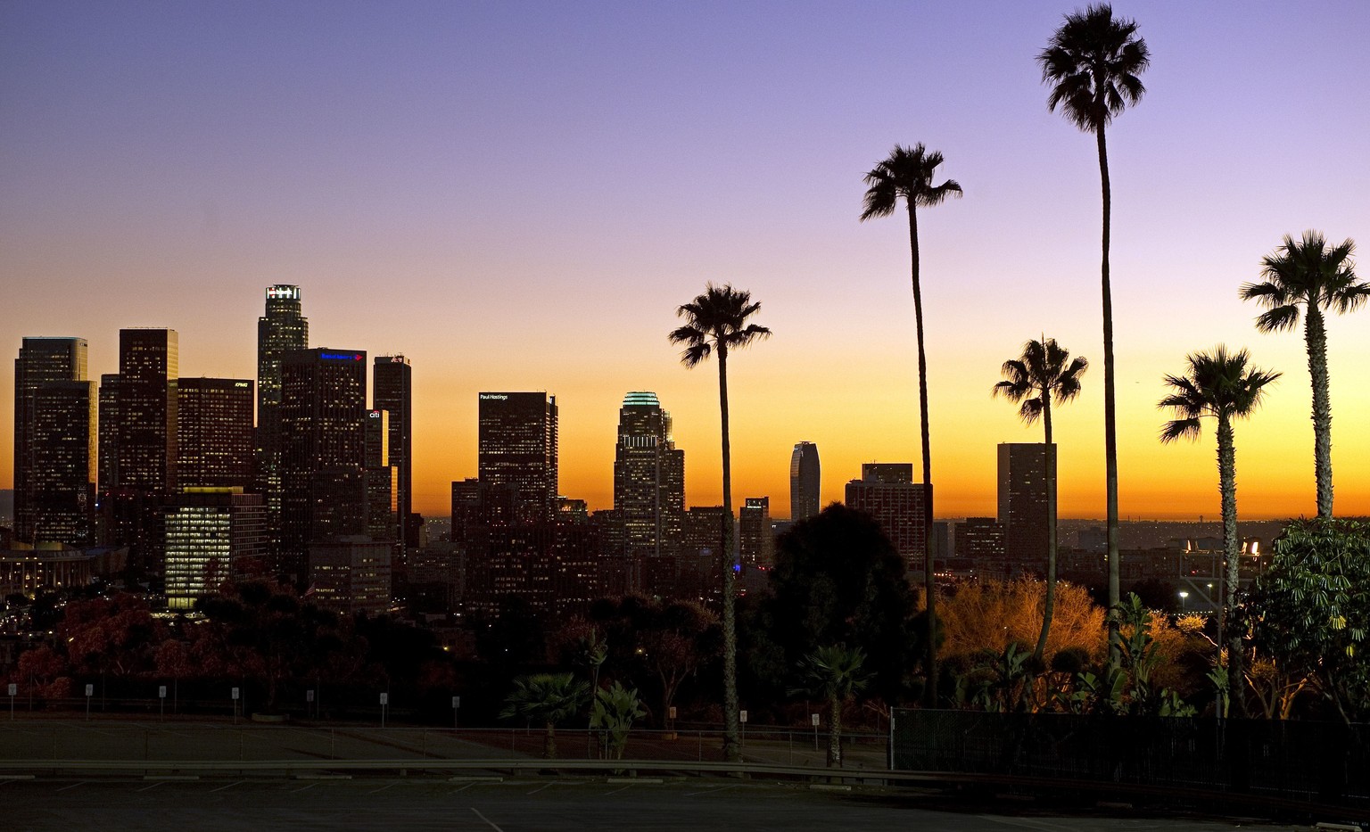 FILE - In this Jan. 21, 2011, file photo, the sun sets beyond the Los Angeles skyline, as seen from Dodger Stadium in Los Angeles. The U.S. Geological Survey said a magnitude-3.6 quake hit at about 11 ...
