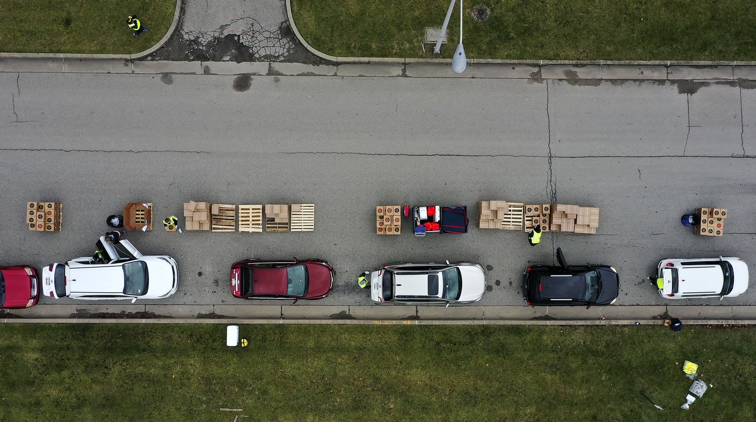 Volunteers load boxes of food into a car during a Greater Pittsburgh Community Food bank drive-up food distribution in Duquesne, Pa., Monday, Nov. 23, 2020. (AP Photo/Gene J. Puskar)