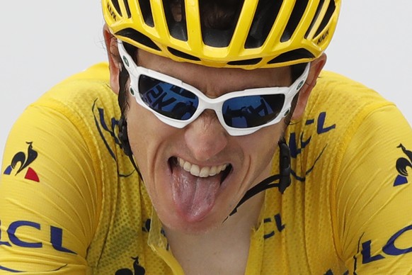 Britain&#039;s Geraint Thomas, wearing the overall leader&#039;s yellow jersey, grimaces as he crosses the finish line of the seventeenth stage of the Tour de France cycling race over 65 kilometers (4 ...