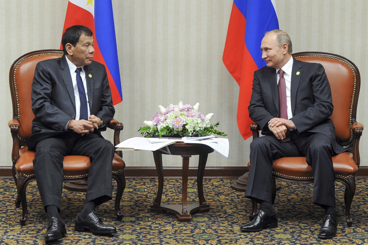Philippine President Rodrigo Duterte, left, listens to Russian President Vladimir Putin during their meeting at the Asia-Pacific Economic Cooperation (APEC) forum in Lima, Peru, Saturday, Nov. 19, 201 ...