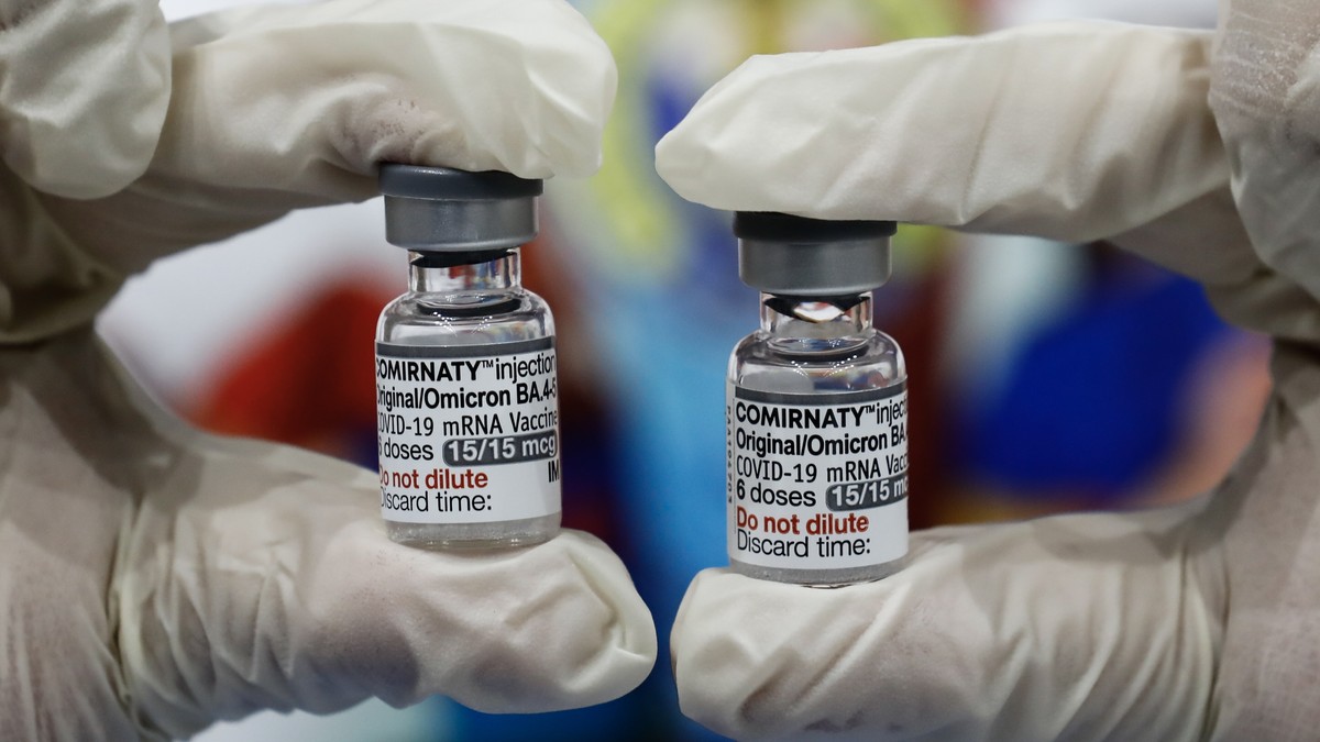 epa10705086 A healthcare worker holds vials of the Pfizer Bivalent COVID-19 vaccine to be administered to fellow healthcare workers at a sports center used as a vaccination facility in San Juan City,  ...