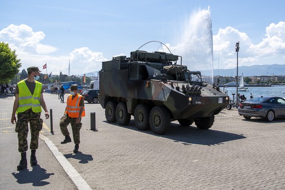 Swiss army soldiers walk past an army vehicle and the Jet d&#039;eau fountain is seen near Villa La Grange in Geneva, Switzerland, on Friday, June 11, 2021. The &quot;Villa La Grange&quot; is the offi ...