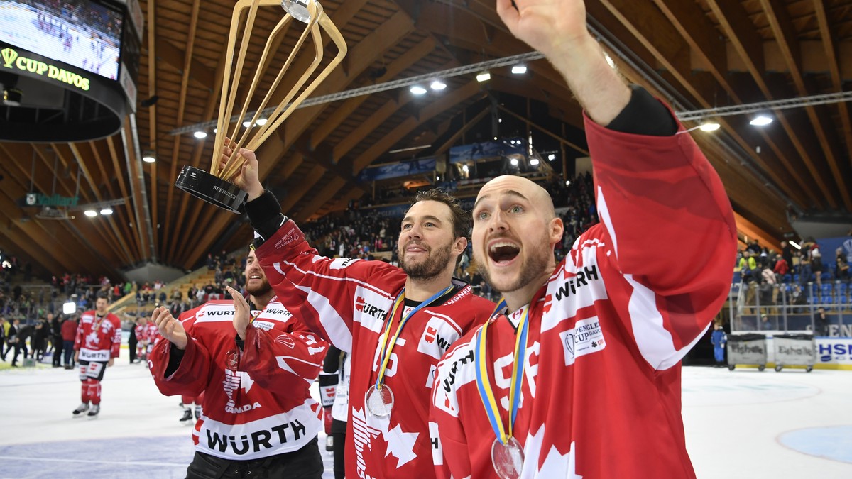 Team Canada's Pierre-Alexandre Parenteau and Maxim Noreau, from left, with the Trophy after winning the final game between Team Canada and Team Suisse at the 91th Spengler Cup ice hockey tourname ...