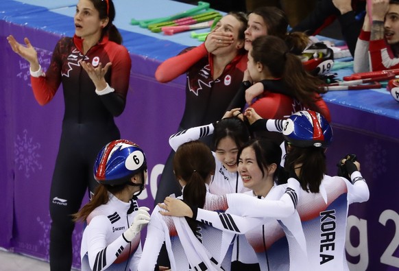 Members of South Korea&#039;s women&#039;s 3000 meters short track speedskating relay team react after winning the gold medal in the Gangneung Ice Arena at the 2018 Winter Olympics in Gangneung, South ...