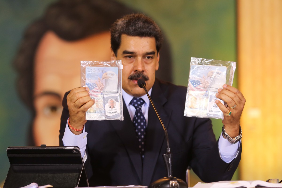 This photo released by Venezuela's Miraflores presidential press office, President Nicolas Maduro shows what Venezuelan authorities claim are identification documents of former U.S. special force ...