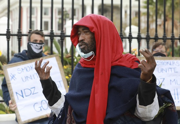 FILE - In this June 2, 2020 file photo, demonstrators protest against the tobacco ban outside parliament in Cape Town, South Africa. South Africa is three months into a ban on the sale of cigarettes a ...