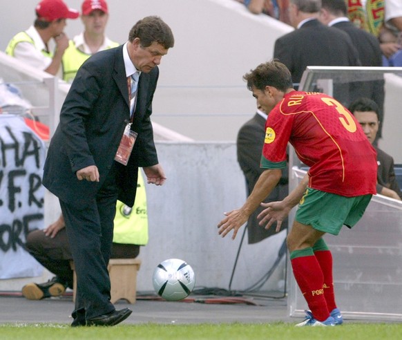 Otto Rehhagel (L), the German coach of the Greek national team, gives the ball to Portuguese player Rui Jorge during the Group A match of the EURO 2004 at Estadio do Dragao in Porto, Saturday 12 June  ...