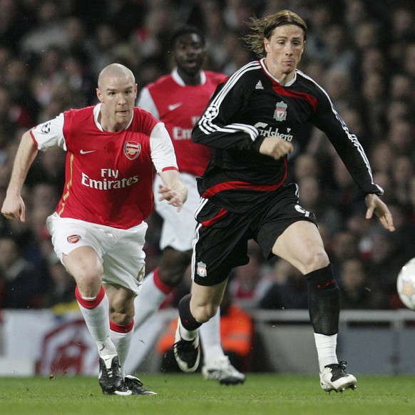 Arsenal's Philippe Senderos, left, and Liverpool's Fernando Torres, right, vie for the ball during their Champions League quarterfinal first leg soccer match at Arsenal's Emirates Stadi ...