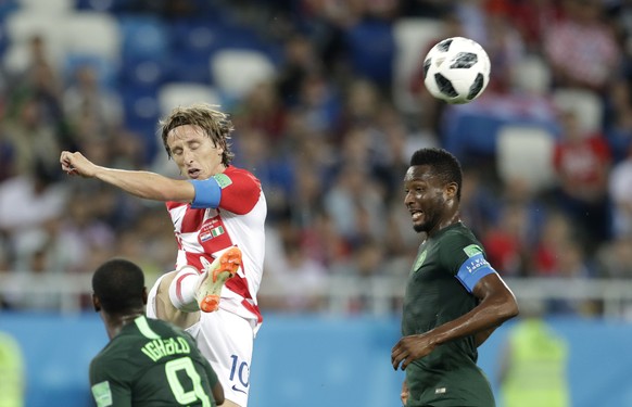Croatia&#039;s Luka Modric, middle, kicks the ball as Nigeria&#039;s John Obi Mikel, right, and teammate watches during the group D match between Croatia and Nigeria at the 2018 soccer World Cup in th ...