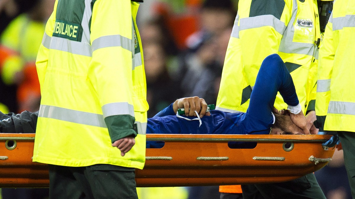 epa07970194 Everton's Andre Gomes (bottom) is stretchered off the pitch after being injured during the English Premier League soccer match between Everton FC and Tottenham Hotspur at the Goodison ...