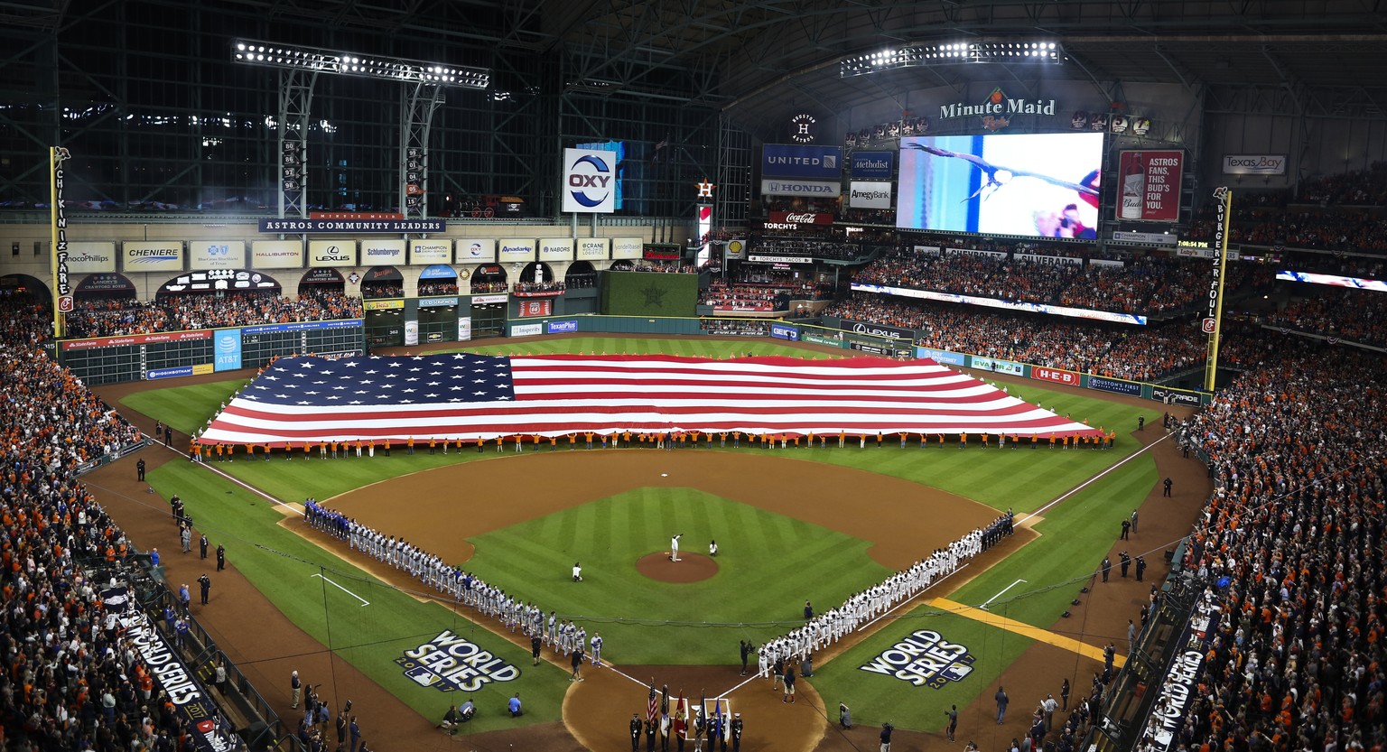 Teams line up for the national anthem before Game 3 of baseball&#039;s World Series between the Houston Astros and the Los Angeles Dodgers Friday, Oct. 27, 2017, in Houston. (AP Photo/Tim Donnelly)