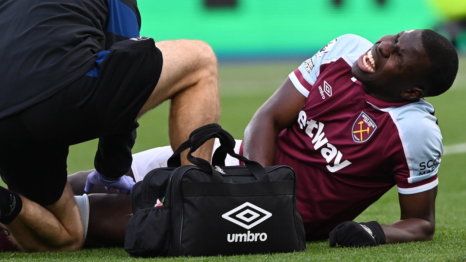 epa09621042 Kurt Zouma of West Ham reacts while receiving medical care after being injured during the English Premier League soccer match between West Ham United and Chelsea FC in London, Britain, 04  ...