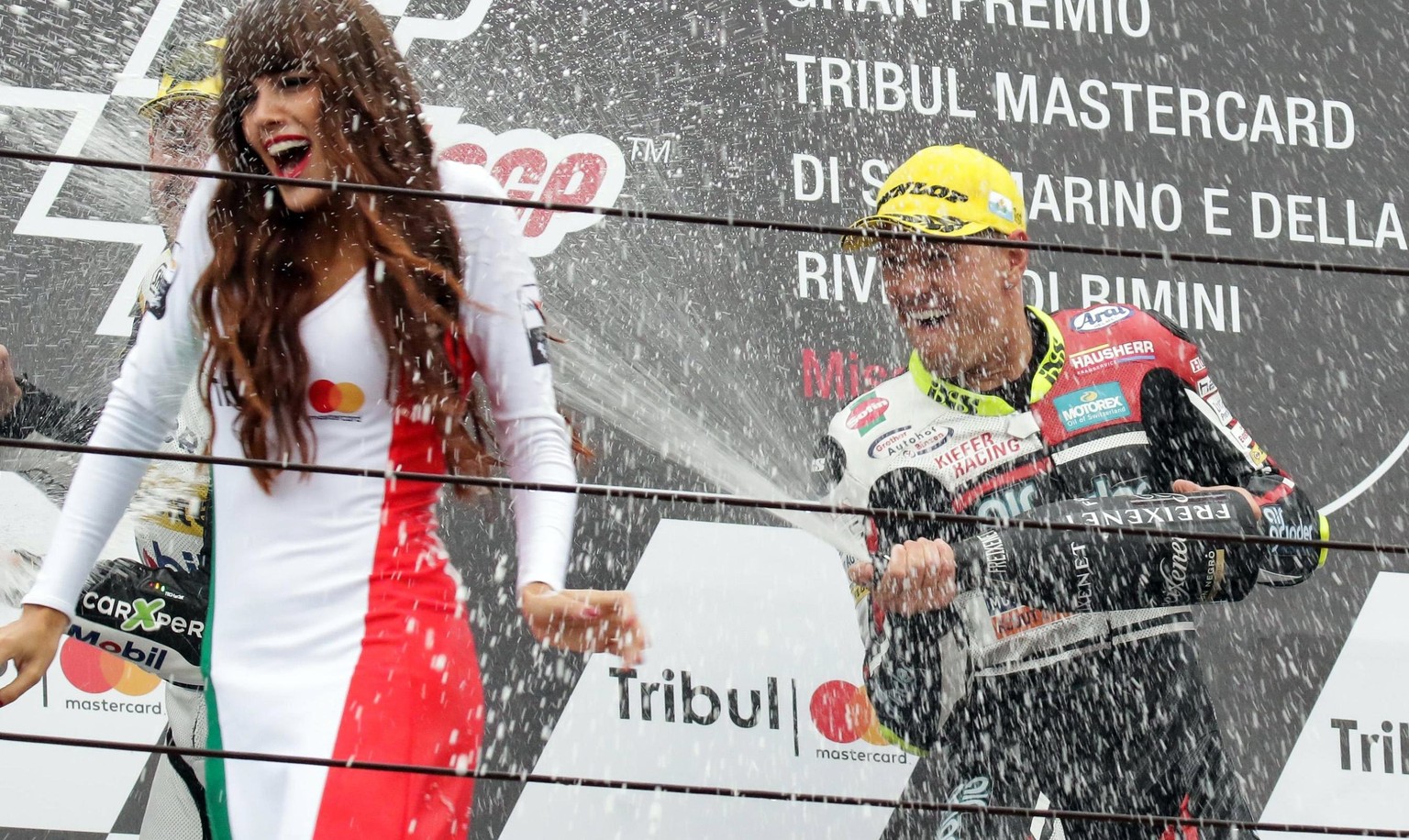 epa06196236 Swiss rider Dominique Aegerter of Kiefer Racing celebrates on the podium after winning the Moto2 Grand Prix of San Marino and Riviera of Rimini at Misano circuit, in Misano Adriatico, Ital ...