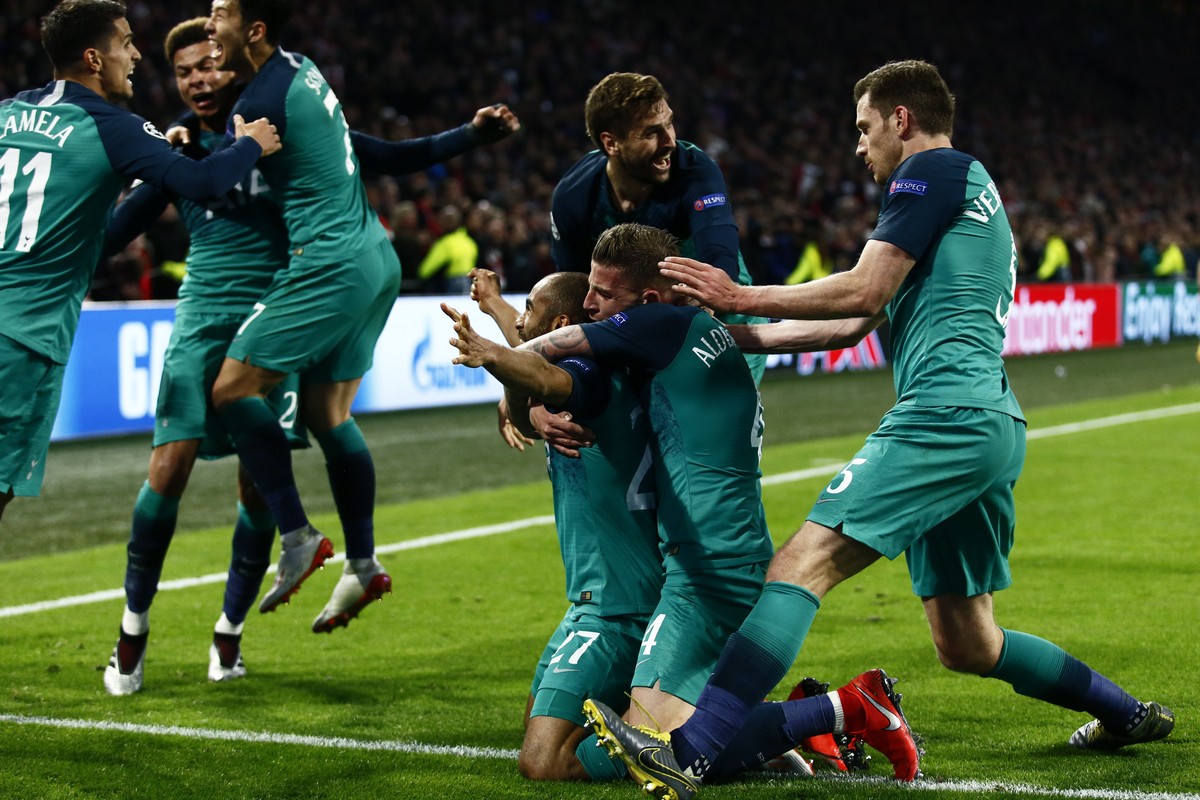 Tottenham's Lucas Moura, center, kneeling, celebrates after scoring his side's third goal during the Champions League semifinal second leg soccer match between Ajax and Tottenham Hotspur at  ...