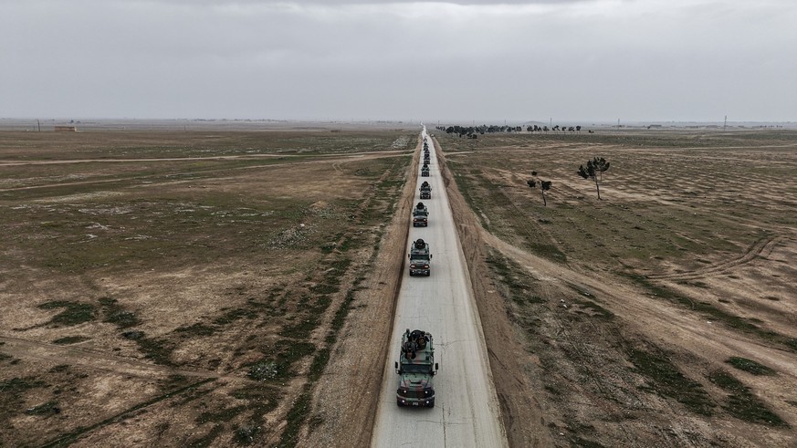 AL-HASAKAH, SYRIA - FEBRUARY 2: A convoy, belonging to the Syrian Ministry of Interior, consists of eight armored personnel carriers, numerous four-wheel-drive pickup trucks, ambulances and a mobile b ...