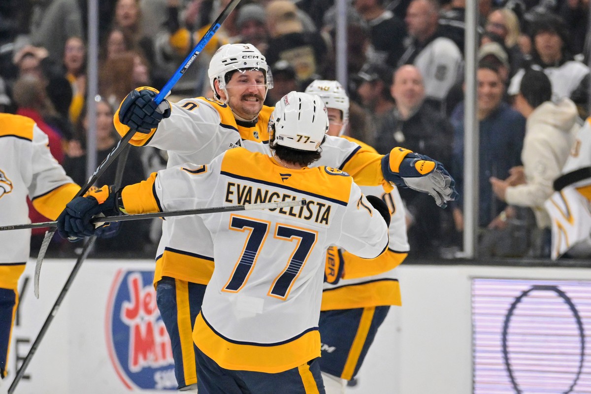 Nashville Predators right wing Luke Evangelista (77) is embraced by Predators' left wing Filip Forsberg (9) after scoring the winning goal during the shootout of an NHL hockey game, against the L ...