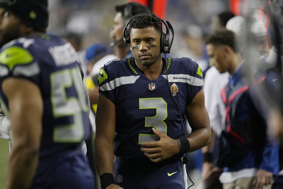 Seattle Seahawks quarterback Russell Wilson wears a headset on the sideline during the second half of the team&#039;s NFL preseason football game against the Denver Broncos, Saturday, Aug. 21, 2021, i ...