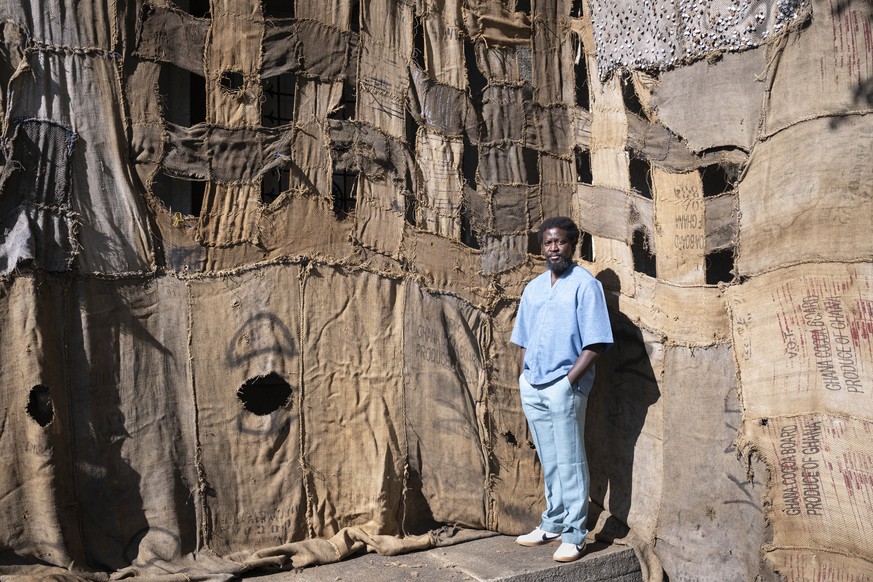 The Ghanaian artist Ibrahim Mahama (born 1987) takes a pose front of his installation made of recycled jute sacks from the cocoa trade - highlighting colonial legacies and global ties between Ghana an ...