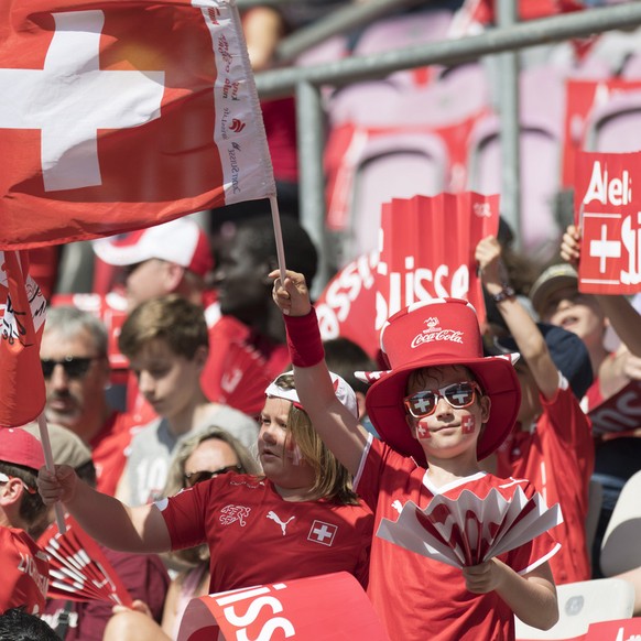 Swiss fans cheer with Swiss flags before an international friendly test match between the national soccer teams Switzerland and Belgium, at the stade de Geneve stadium, in Geneva, Switzerland, Saturda ...