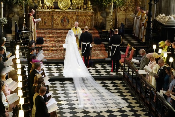 Britain&#039;s Prince Harry and Meghan Markle stand in front of Archbishop of Canterbury Justin Welby during their wedding at St. George&#039;s Chapel in Windsor Castle in Windsor, near London, Englan ...