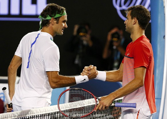 Switzerland&#039;s Roger Federer (L) shakes hands with Bulgaria&#039;s Grigor Dimitrov after Federer won their third round match at the Australian Open tennis tournament at Melbourne Park, Australia,  ...